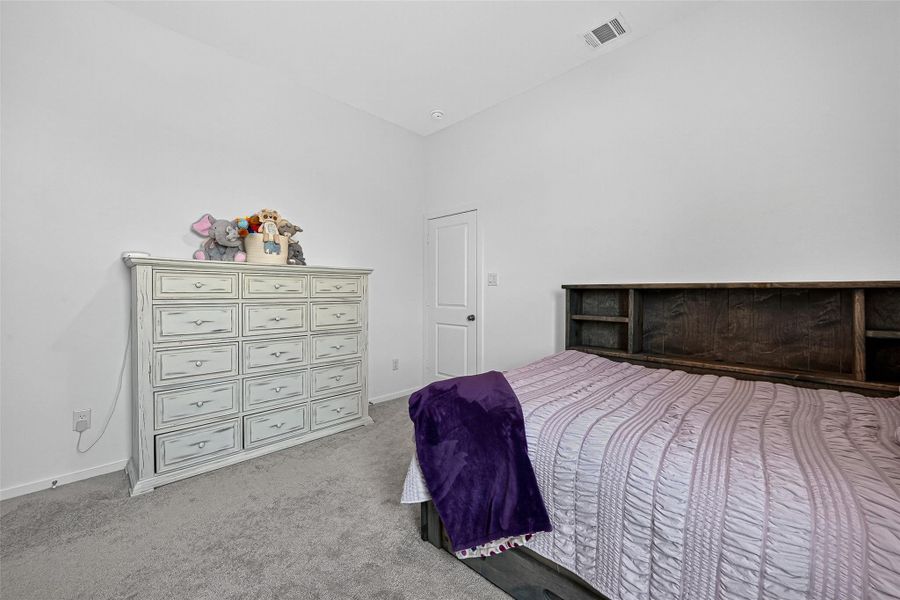 Upstairs secondary bedroom with plush carpet and ample storage. Upstairs secondary bedroom with plush carpet and ample storage.