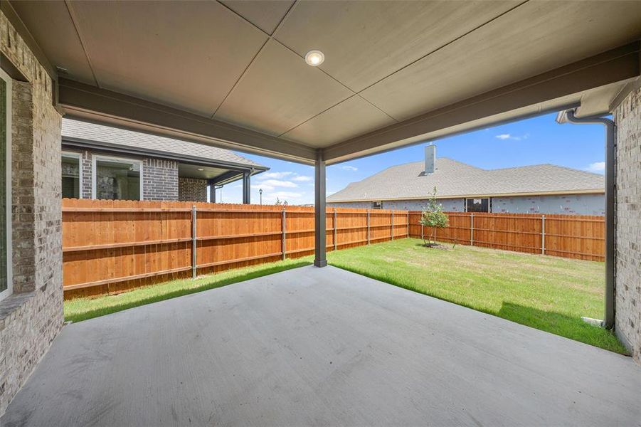 Fenced backyard with a patio area