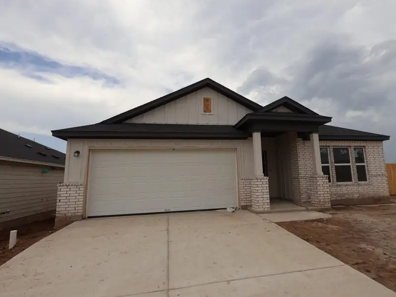 Front exterior of a new home in Willow Springs, Buda, TX, highlighting curb appeal (Image 2). Front exterior of a new home in Willow Springs, Buda, TX, highlighting curb appeal (Image 2).