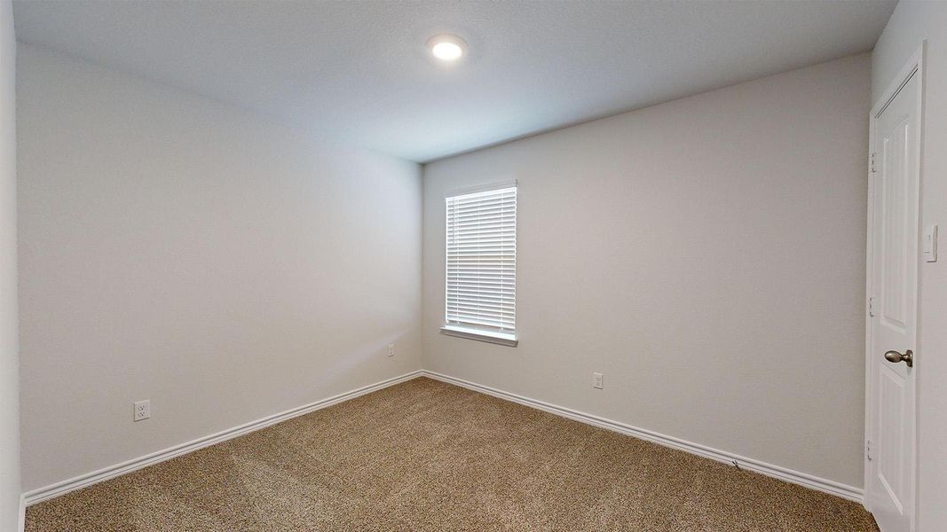 Spare room featuring baseboards and carpet flooring Spare room featuring baseboards and carpet flooring