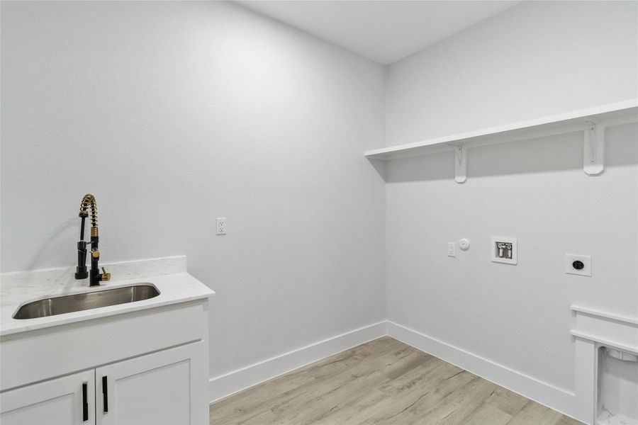 Laundry area featuring hookup for a gas dryer, electric dryer hookup, light wood-style flooring, and hookup for a washing machine