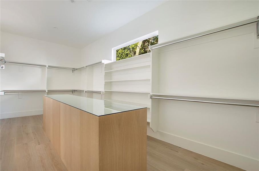 Spacious closet with light wood-type flooring