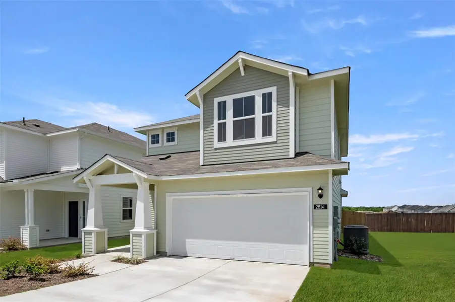 View of front of house featuring concrete driveway, an attached garage, a shingled roof, and a porch