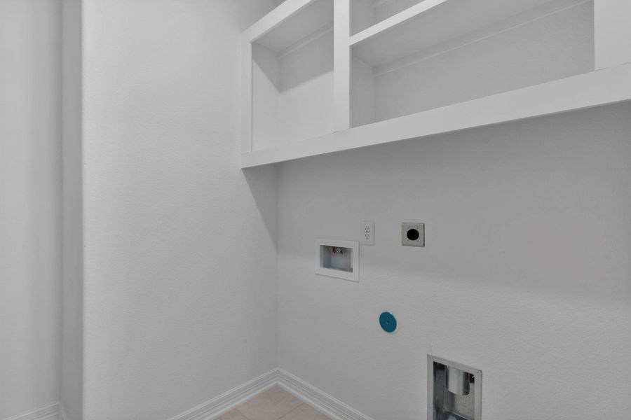 The laundry room layout is carefully planned for optimal workflow with designated areas for washing, drying, and storing.