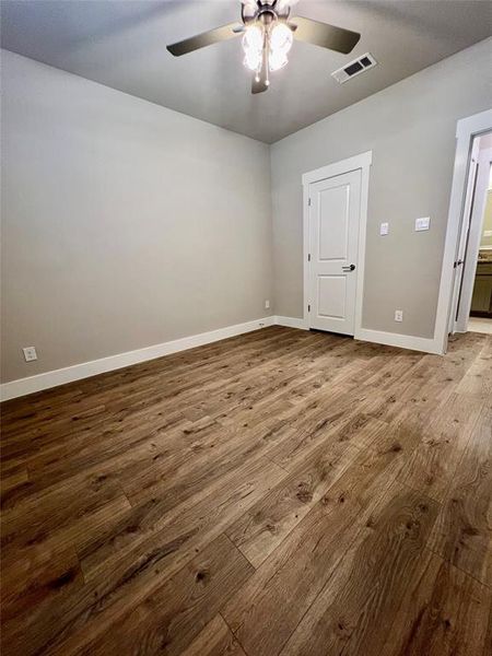 2nd bedroom featuring wood-type flooring and ceiling fan