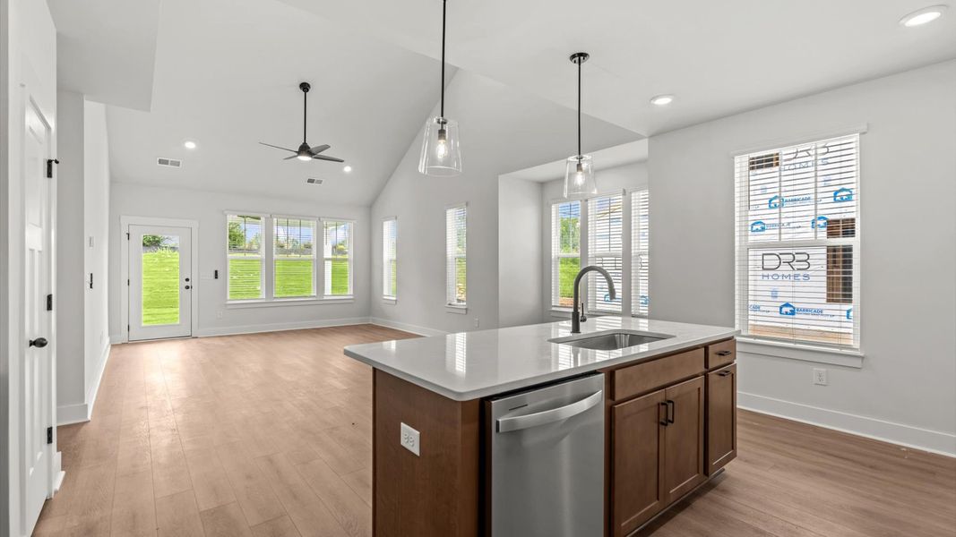Exceptional kitchen featuring a spacious island, eye-catching pendant lights, and modern finishes