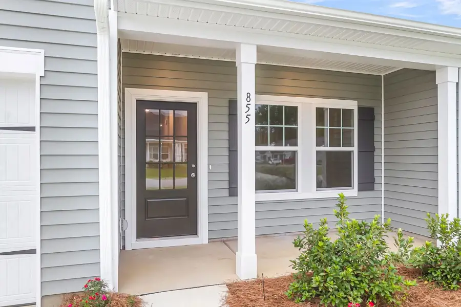 A warm welcome begins at this charming front exterior.