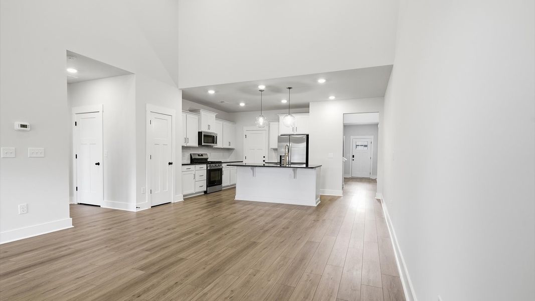 Elegant family room with hardwood flooring and open-concept flow in this first-class DRB Homes design Elegant family room with hardwood flooring and open-concept flow in this first-class DRB Homes design
