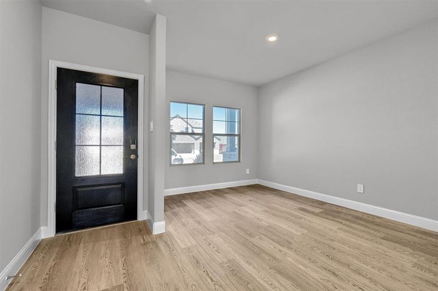 Foyer entrance with light wood-type flooring