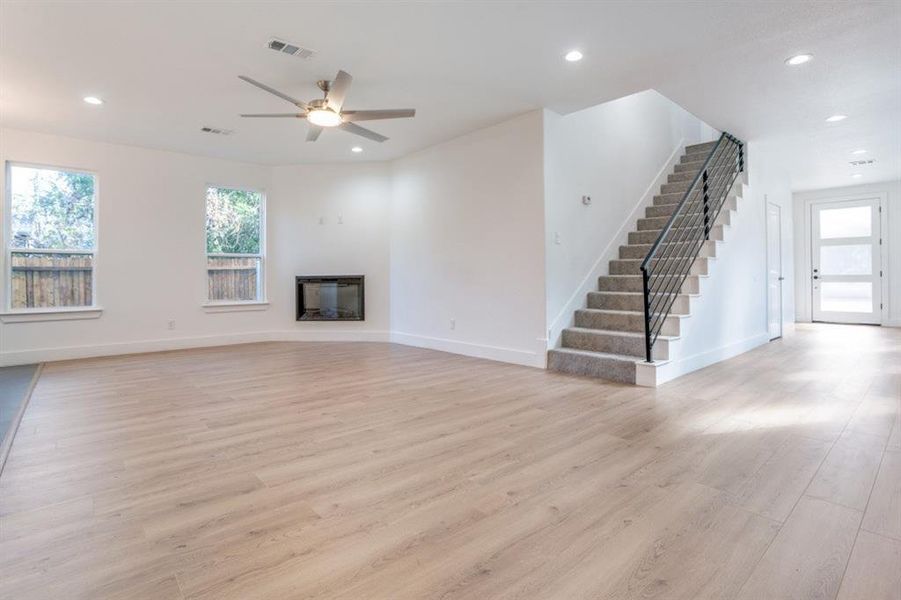 living room featuring ceiling fan and light hardwood / wood-style flooring