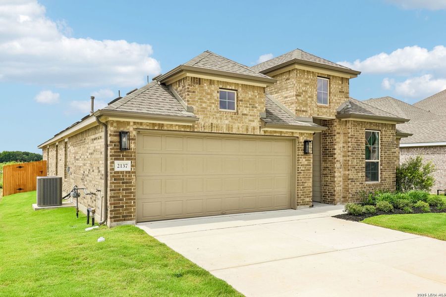 Front exterior of a new home in Stream Waters, Seguin, TX, highlighting curb appeal (Image 2). Front exterior of a new home in Stream Waters, Seguin, TX, highlighting curb appeal (Image 2).