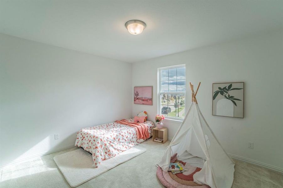 Carpeted bedroom with baseboards Carpeted bedroom with baseboards