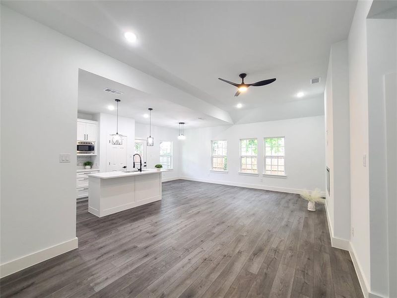 Unfurnished living room featuring dark wood-type flooring, recessed lighting, and a ceiling fan Unfurnished living room featuring dark wood-type flooring, recessed lighting, and a ceiling fan