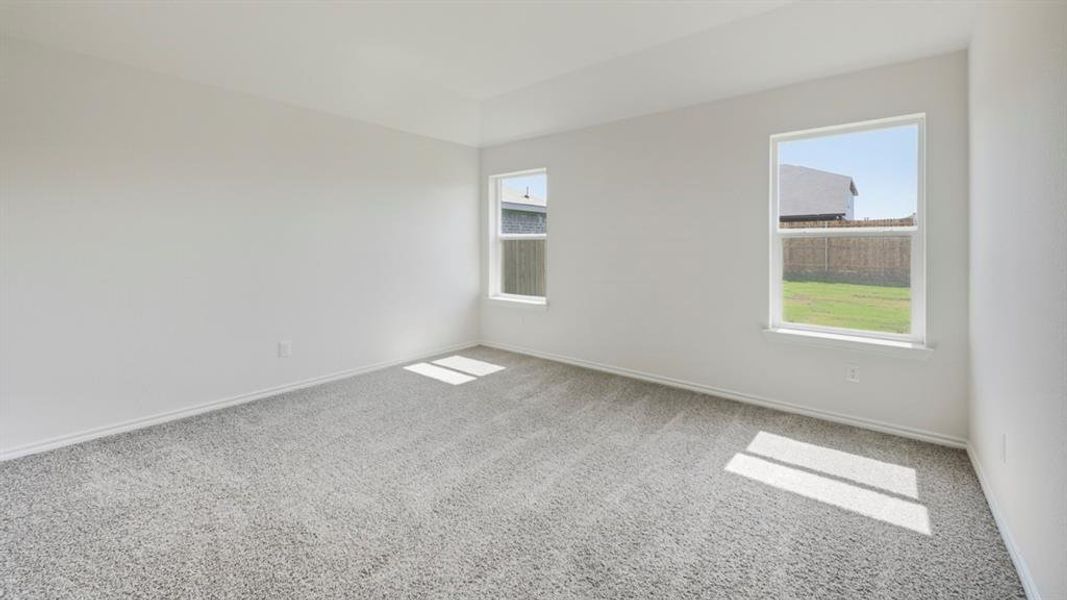 Empty room with light carpet and baseboards