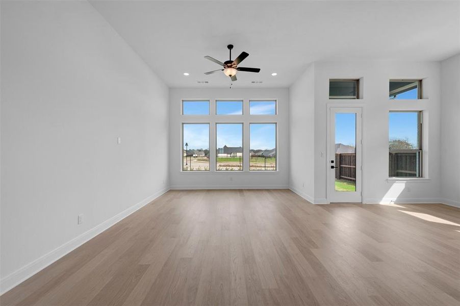 Spare room with light wood-type flooring, ceiling fan, and recessed lighting