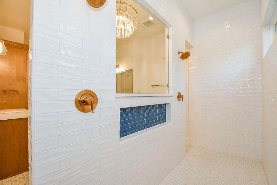 This thoughtfully designed shared shower space offers both style and function in the primary bath. This thoughtfully designed shared shower space offers both style and function in the primary bath.
