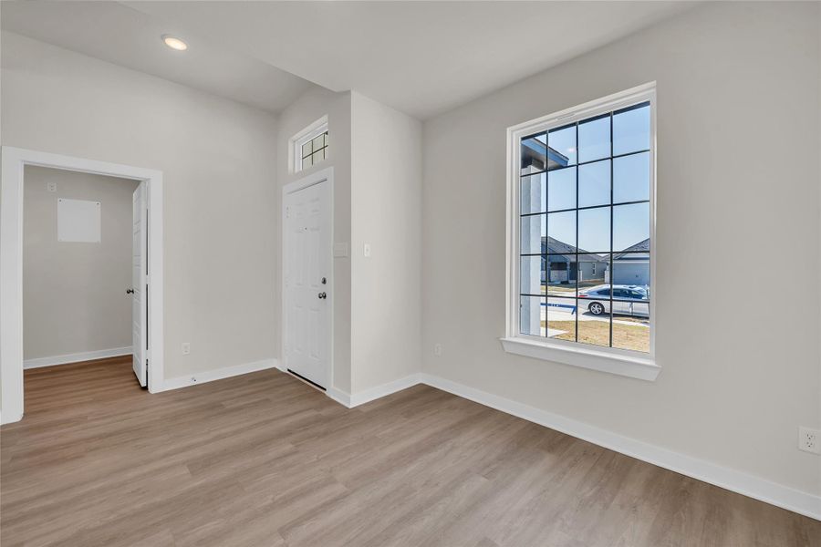 Spare room with recessed lighting, baseboards, and light wood finished floors