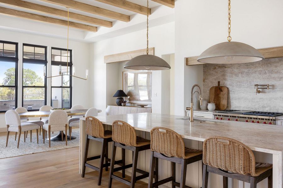 Beautiful gourmet kitchen with waterfall island looking towards dining area