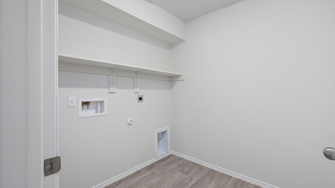 Washroom featuring gas dryer hookup, light wood-style flooring, washer hookup, and hookup for an electric dryer