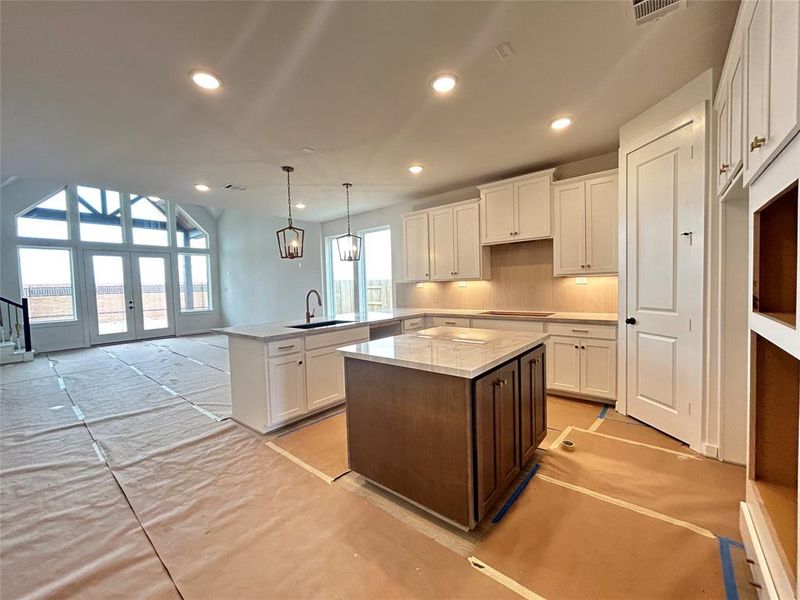 The open kitchen features modern finishes, creating a sleek and stylish space for cooking and entertaining. With high-end appliances and elegant countertops, it seamlessly blends functionality with contemporary design.