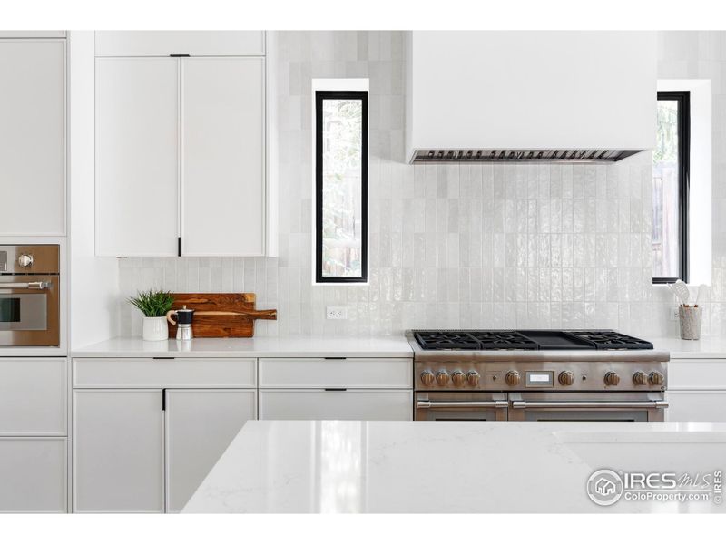 Including a vented six-burner gas range with a griddle and double ovens, a combination speed oven/microwave, two dishwashers, 30-inch cabinet-front refrigerator and freezer columns, plus an integrated Miele espresso machine.