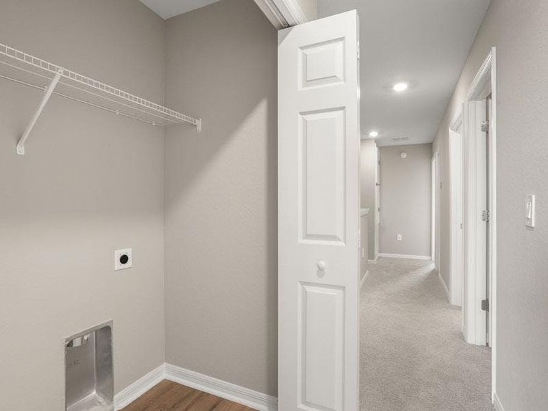 The laundry is conveniently located near the bedrooms - Aruba townhome by Highland Homes
