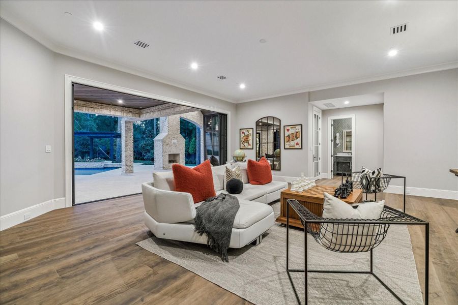 DOWNSTAIRS GAME ROOM WITH NANAWALL LEADING TO SUMMER KITCHEN