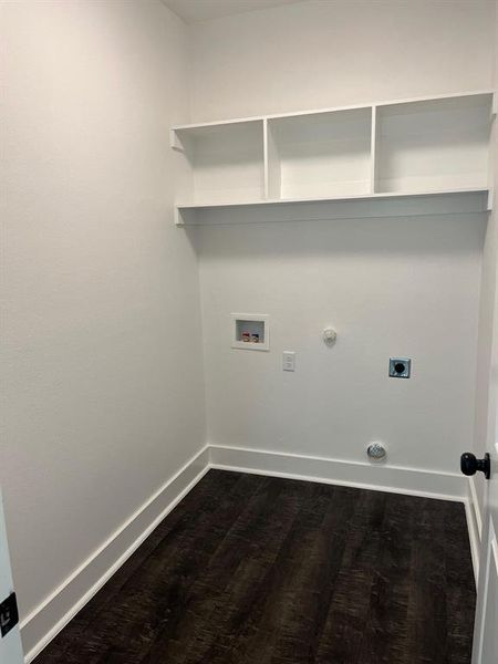 Washroom featuring gas dryer hookup, dark wood-type flooring, washer hookup, and hookup for an electric dryer