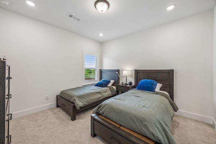 Bedroom featuring light colored carpet and recessed lighting