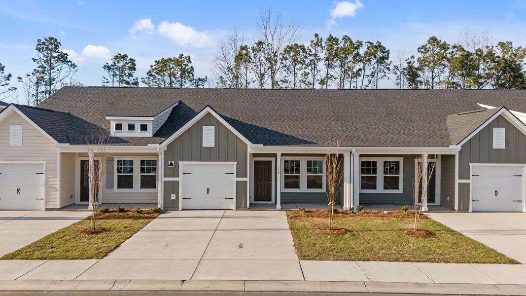 Front exterior of a new home in Blue Heron Retreat, Little River, SC, highlighting curb appeal (Image 2). Front exterior of a new home in Blue Heron Retreat, Little River, SC, highlighting curb appeal (Image 2).