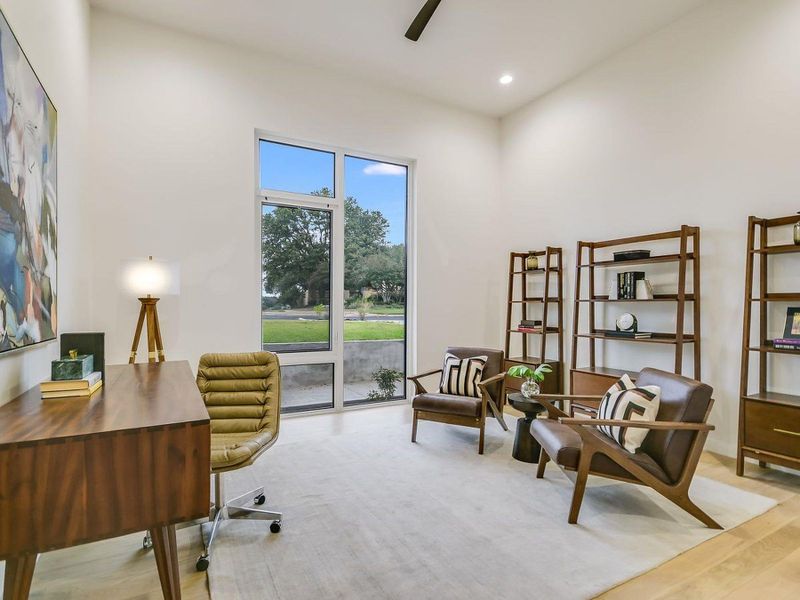 Bright study with towering windows offers a peaceful workspace. Bright study with towering windows offers a peaceful workspace.