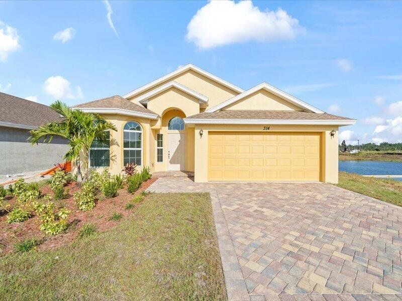 Front exterior of a new home in , Fort Pierce, FL, highlighting curb appeal (Image 1).