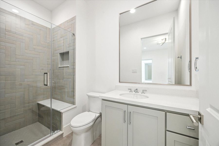En-suite bathroom for final second-floor bathroom features a glass-enclosed freestanding shower with Quartz counters. En-suite bathroom for final second-floor bathroom features a glass-enclosed freestanding shower with Quartz counters.