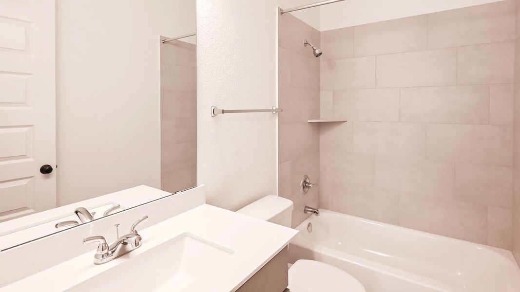 Full bath featuring toilet, shower / washtub combination, and vanity Full bath featuring toilet, shower / washtub combination, and vanity