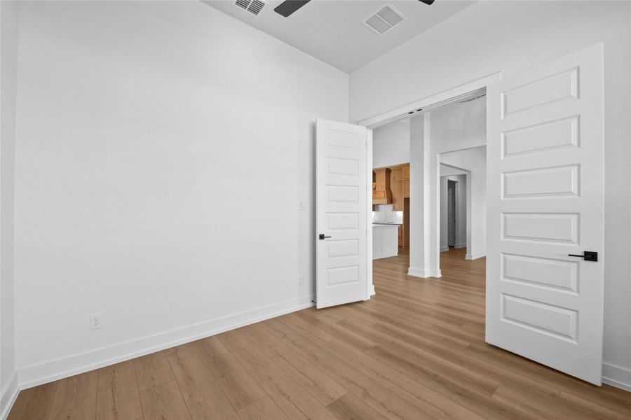 Unfurnished bedroom with light wood-type flooring and ceiling fan Unfurnished bedroom with light wood-type flooring and ceiling fan