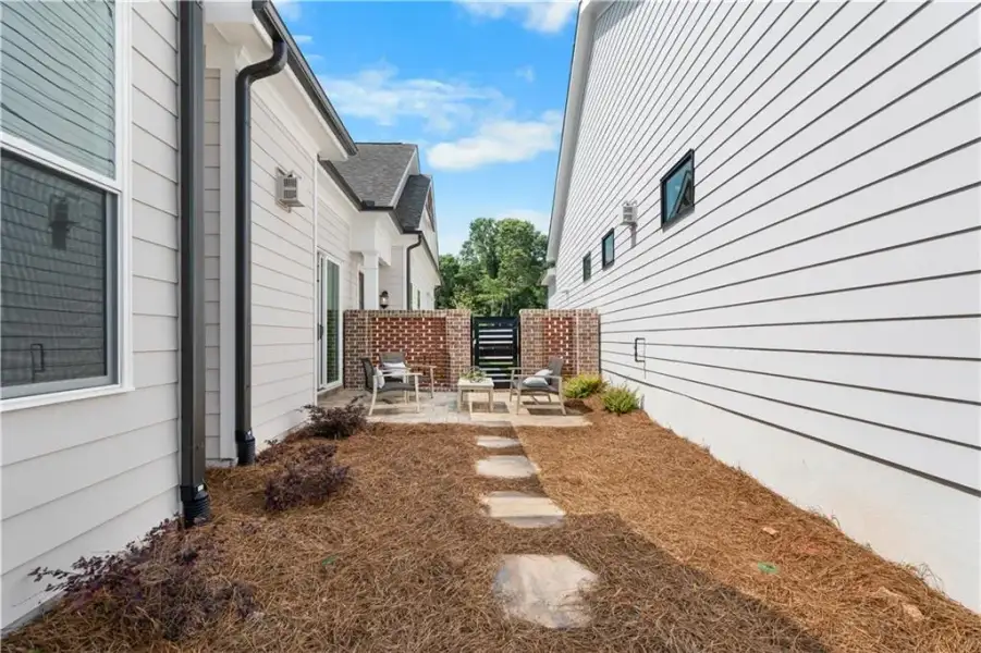 Exterior details and patio area of a home in The Villas at Aberdeen, Hoschton (Image 21).