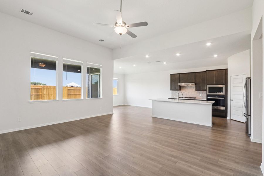 Unfurnished living room with recessed lighting, ceiling fan, and light wood-style flooring Unfurnished living room with recessed lighting, ceiling fan, and light wood-style flooring