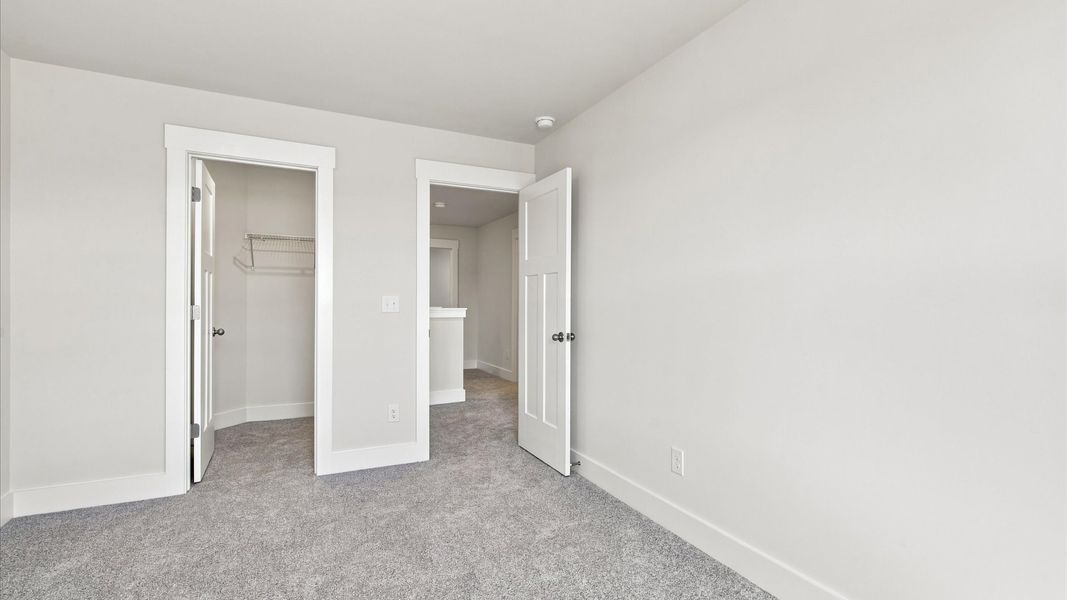 Refined bedroom design with large windows for daylight-filled mornings and peaceful views