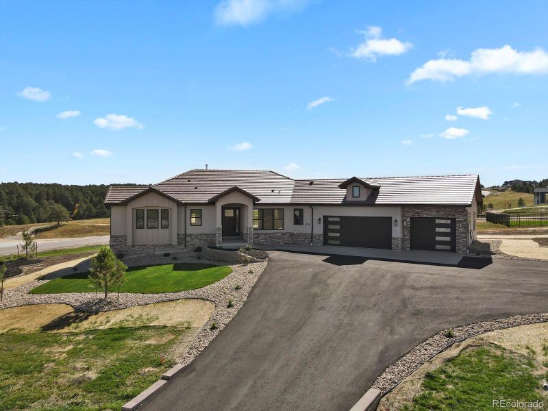 Covered entry and landscaping complete with auto-sprinkler system