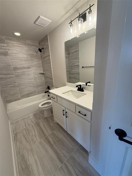 Bathroom featuring tub / shower combination and vanity Bathroom featuring tub / shower combination and vanity