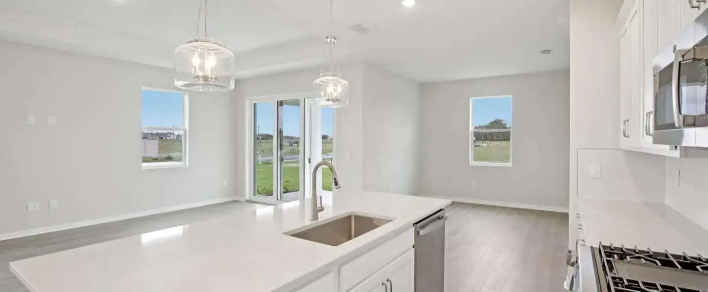 Kitchen looks out to the open concept living space - Representative images and renderings are for illustrative purposes. Actual structural options and design finishes of home may vary.