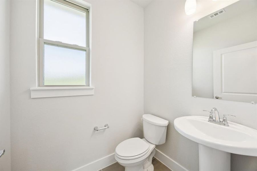Bathroom with toilet and baseboards