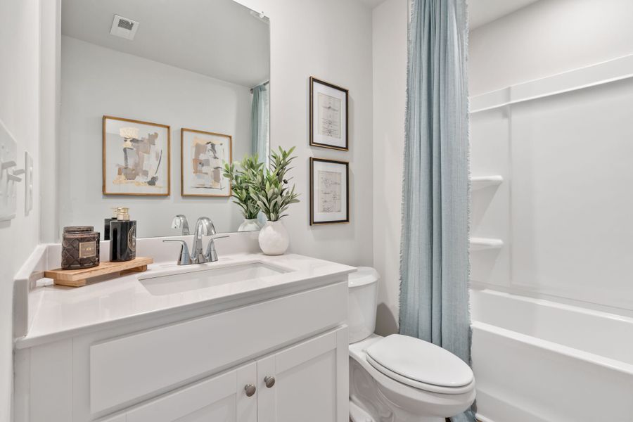 A bathroom with a sink toilet and a bathtub. A bathroom with a sink toilet and a bathtub.