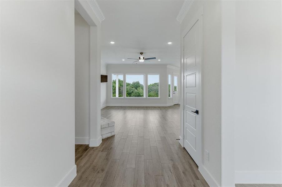 Spacious interior featuring wood-finish flooring, recessed lighting, and a contemporary ceiling fan