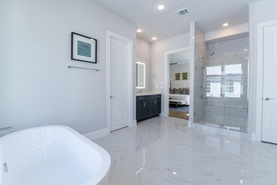 Separate free standing tub and shower in this massive primary bathroom!