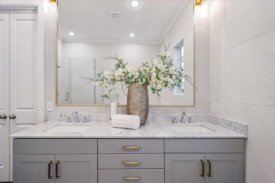Spa-inspired primary bath with dual sinks and Carrara countertops.