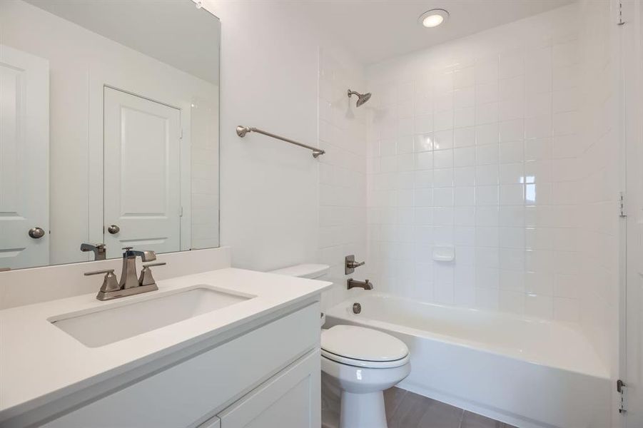 Bathroom with toilet, vanity, shower / bath combination, and recessed lighting