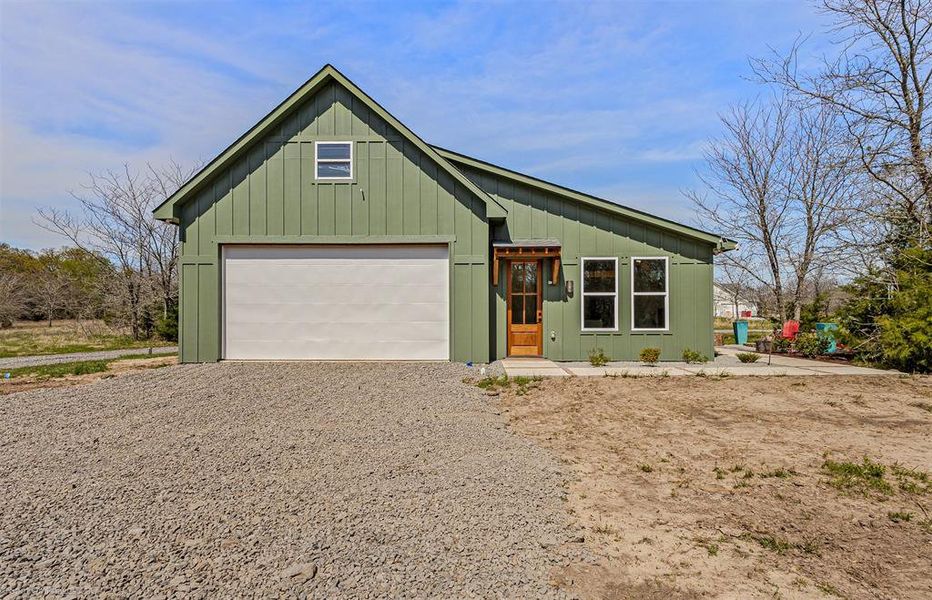 Gravel drive up entrance to 800+ sf shop wtih 2 roll up doors