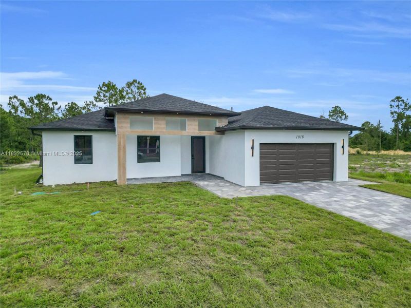 Front exterior of a new home in , Lehigh Acres, FL, highlighting curb appeal (Image 37).