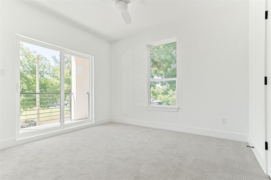 Carpeted empty room with ceiling fan